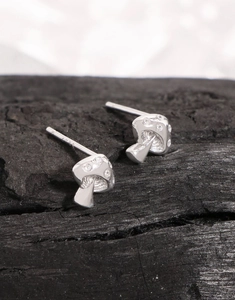 Macro shot of S925 sterling silver mushroom stud earrings with cubic zirconia stones