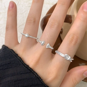 Minimalist S925 sterling silver shell open ring set worn with casual knitwear