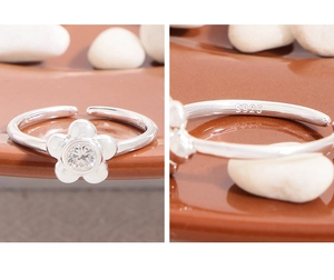 Detail of S925 sterling silver hallmark on floral open ring with zircon center