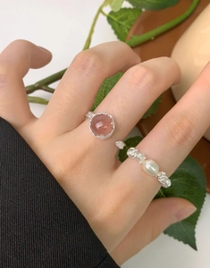 Close-up of S925 silver rings set featuring strawberry quartz and a white oval pearl