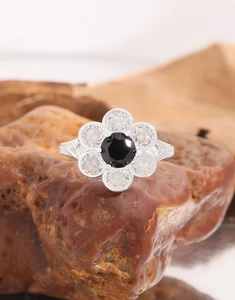 Macro view of a S925 silver flower ring with black zircon stone and vintage carving
