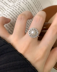 Macro shot of S925 silver halo ring with white bread pearl and sparkling cubic zirconia
