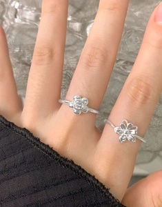 Detailed view of S925 sterling silver flower rings with cubic zirconia inlay on finger