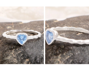 Macro detail of S925 sterling silver ring showing heart-shaped blue zircon and ripple band