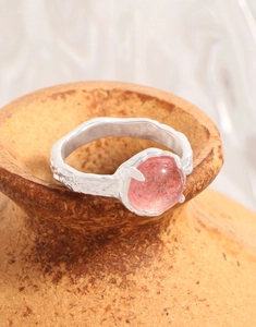 Macro shot of S925 sterling silver ring with natural pink strawberry quartz gemstone