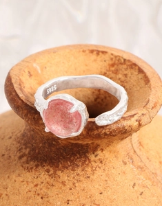 Detail view of S925 sterling silver stamp and pink strawberry quartz stone on lava texture ring