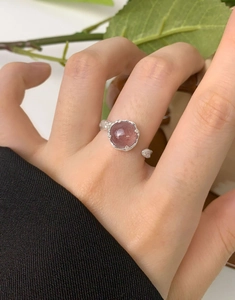 Detail view of S925 sterling silver strawberry quartz ring with texture on finger
