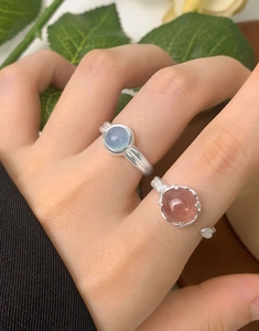 Close-up of S925 silver rings with natural strawberry quartz and light blue gemstones