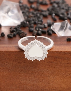 Vue macro d'une bague coeur en argent S925 avec halo de zircons et gravure interne