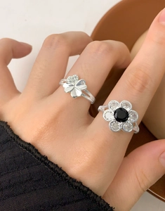 Detail of S925 silver flower ring and clover design with sparkling zircon stones