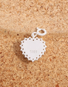 Detail view of the S925 sterling silver heart pendant back with fine floral edge design