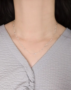 Dettaglio della catena minimalista in argento sterling S925 indossata sulla clavicola