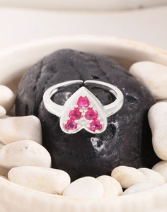 Macro detail of S925 sterling silver ring with pink zircon heart on black stone