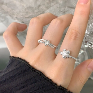 S925 sterling silver open ring set with zircon flower designs worn on a hand