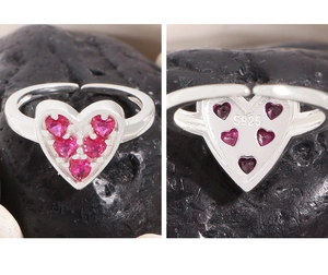 Detail of S925 sterling silver ring showing heart-shaped red zircon stones and hallmarks