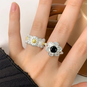 925 sterling silver flower ring set with zircons shown on hand in daily life scene