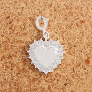 Minimalist S925 sterling silver heart pendant with sparkling cubic zirconia on cork texture