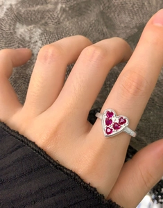 Detail of S925 silver ring featuring a large heart frame set with six red zircons