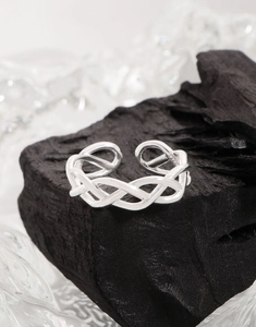 Close-up of S925 sterling silver ring showing intricate woven texture and hallmark