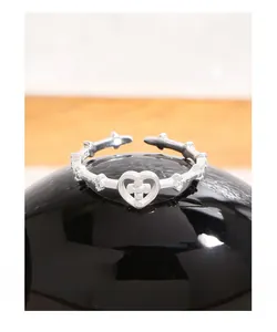 Macro shot of S925 sterling silver ring showing the cross heart and hallmark stamp