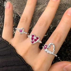 Three S925 sterling silver heart rings with red zircon stones worn on fingers