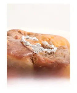 Detailed close-up of S925 silver cross ring with zircons and floral embossing details