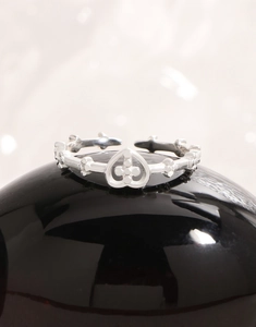 Detail of S925 silver open ring featuring a vine branch design and heart-shaped flower motif