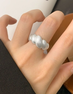 Close-up of S925 sterling silver croissant ring with brushed matte twisted texture