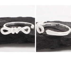 Macro detail showing the S925 sterling silver hallmark inside the bow knot ring