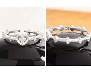 Macro view of S925 sterling silver ring showing the engraved hallmark and heart cross detail
