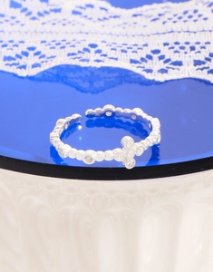 Macro detail of S925 sterling silver cross ring featuring sparkling cubic zirconia stones