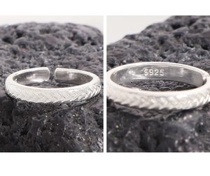 Detail of S925 sterling silver stamp on the inner wall of a braided open ring