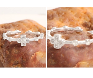 Close-up of S925 sterling silver hallmark and cross ring with inlaid zircon stones