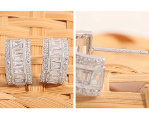 Macro detail of S925 sterling silver stud earrings with square and round zircon stones