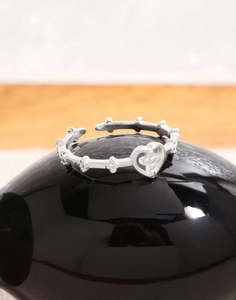 Macro shot of S925 sterling silver adjustable ring with heart and cross-star details