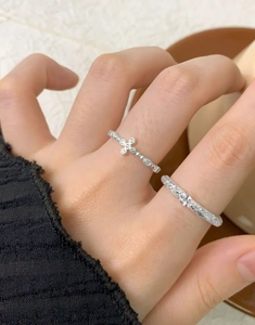 Close-up of S925 sterling silver bubble cross ring with zircon inlay on hand