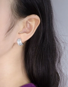 Detail view of S925 sterling silver hoop earrings with channel-set baguette and round zircons