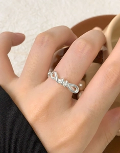 Close-up of elegant S925 sterling silver bow knot ring on model finger