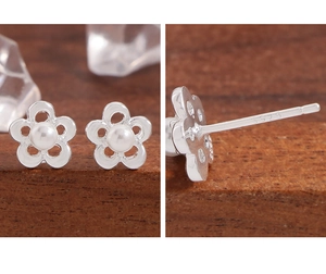 Macro shot of S925 sterling silver stamp and hollow flower design with white pearl