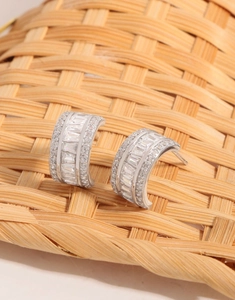 Detailed view of S925 silver hoop earrings with baguette and round cut cubic zirconia stones