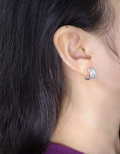 On-ear view of S925 silver half-hoop earrings featuring rectangular and round zirconia stones