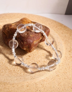Macro detail of natural clear crystal beads with S925 silver spacers on elastic cord