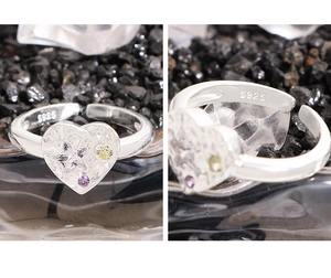 Macro detail of S925 silver heart ring with lava texture and colorful zircon stars