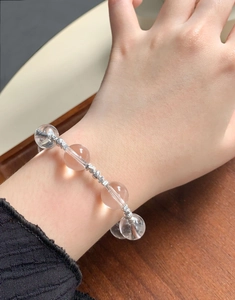 Close-up of crystal bead bracelet with silver spacers worn on a female wrist