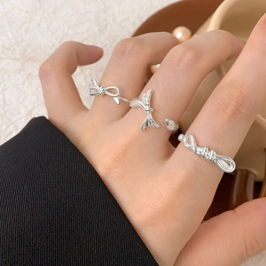 Three-piece S925 sterling silver bow and twisted knot open rings shown on hand