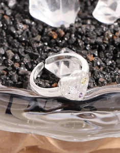 Macro detail of S925 silver heart ring featuring lava texture and star zircon stones