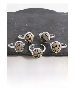 Macro detail of S925 sterling silver hallmarking on adjustable natural spotted stone rings
