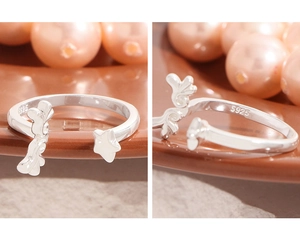 Detail showing S925 hallmark on silver ring with wing and star elements