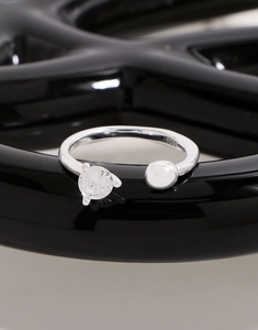 Close-up of S925 sterling silver ring with heart zircon and metal ball detail