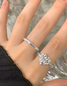 Detail of S925 silver lava texture heart ring with purple and green zircon stones